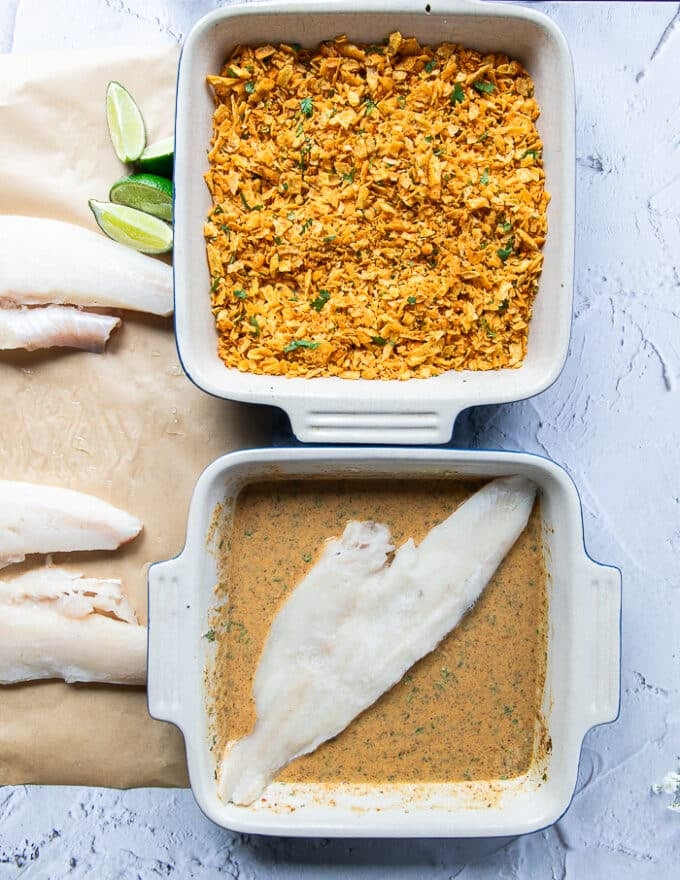 A piece of haddock placed in the wet mixture bowl to begin coating 