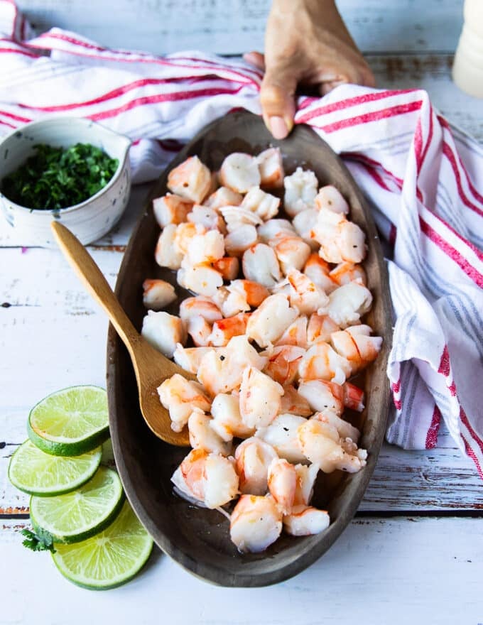 diced shrimp added to a platter and drizzled with lime juice and seasoned lightly