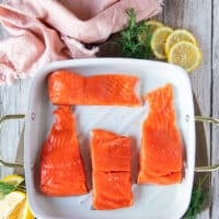 Salmon on a baking pan ready to cover in honey glaze