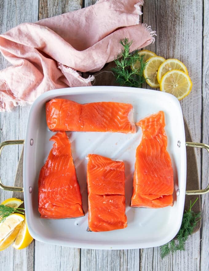 Salmon on a baking pan ready to cover in honey glaze