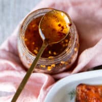 A jar of hot honey and a spoon