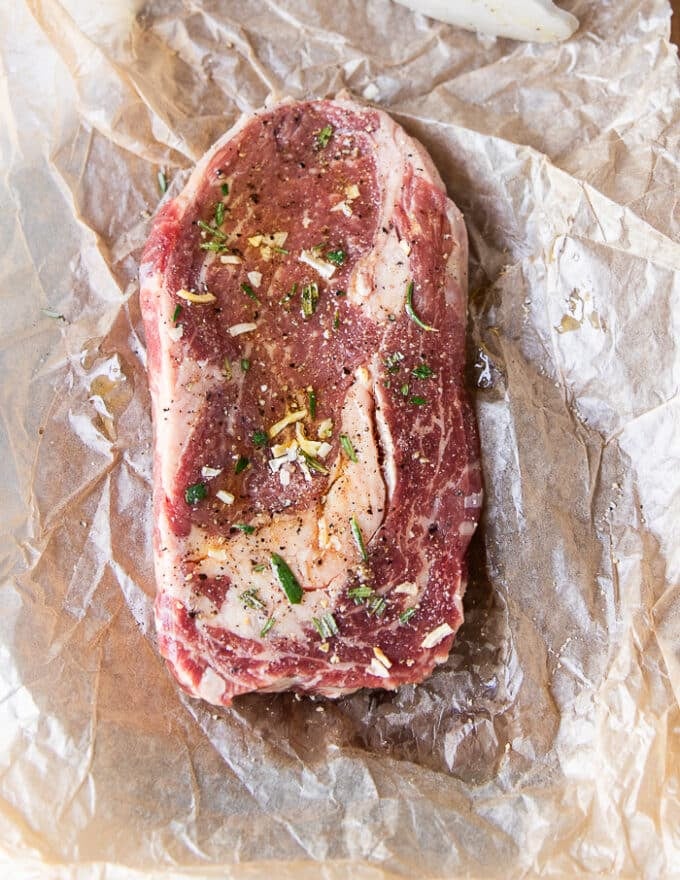 Ingredients for ribeye steak recipe including ribeye steak and seasoning