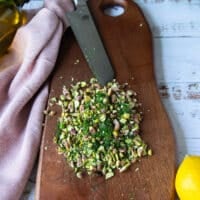 The pistachios and dill are chopped finely first on a cutting board