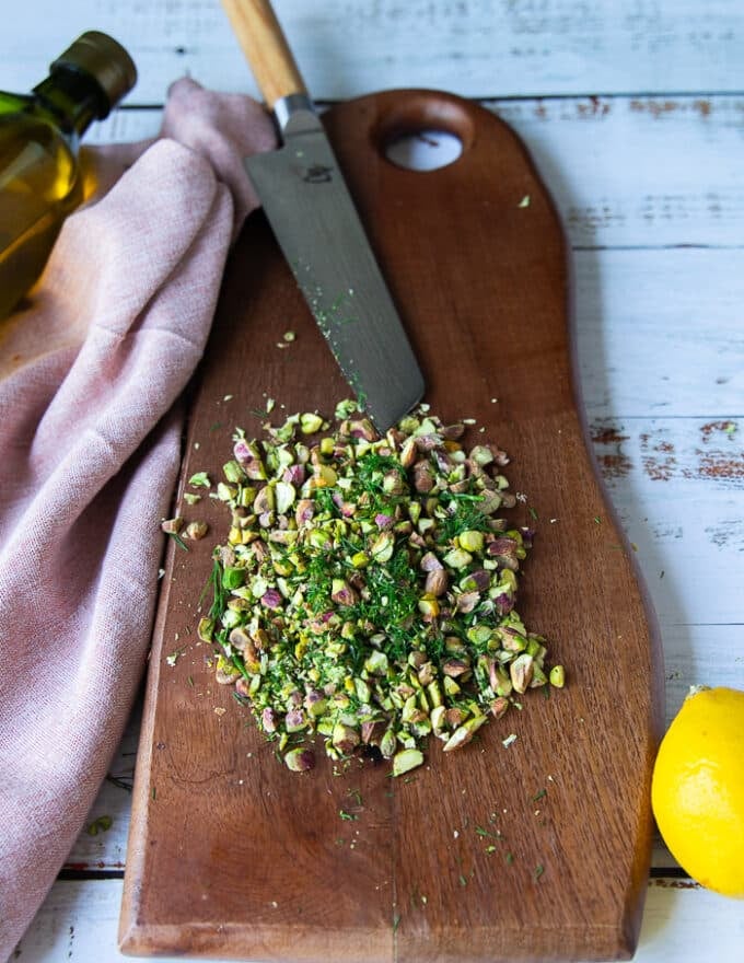 The pistachios and dill are chopped finely first on a cutting board