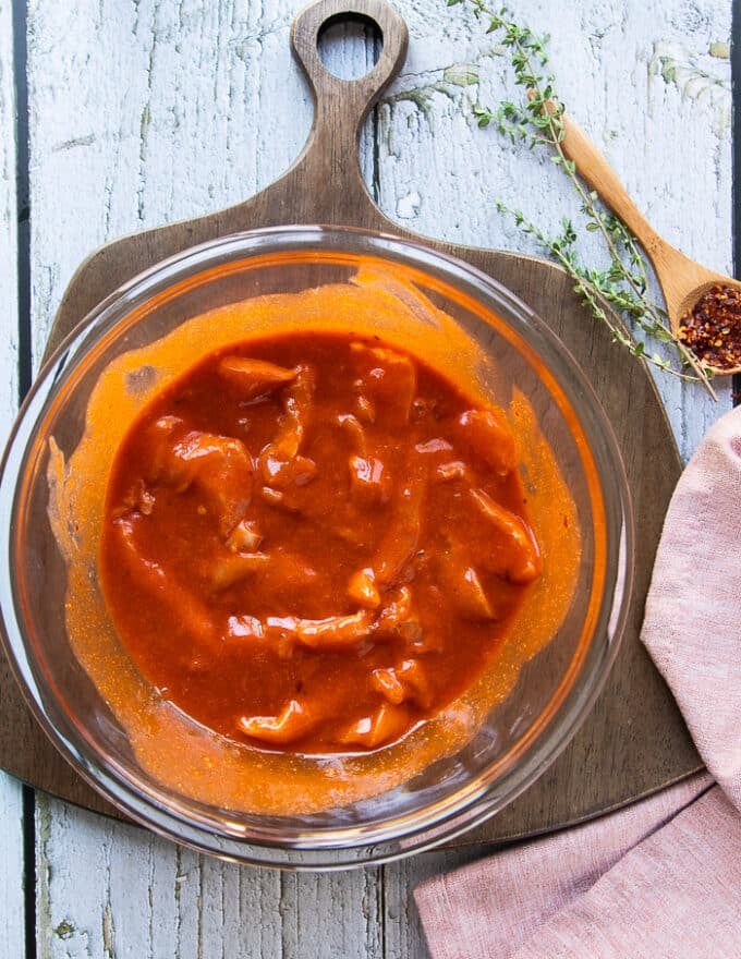 Chicken strips are added to the buffalo sauce along with melted butter, spices and brown sugar and mixed well