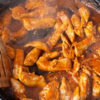 Steaming hot chicken fully cooked in the cast iron skillet and ready