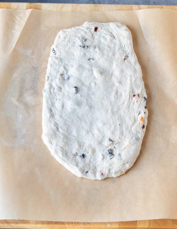 The fougasse dough flattened or rolled into an oval shape first 