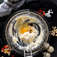 One egg is added to the creamed sugar and butter and vanilla
