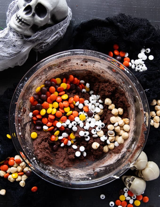 Spooky add ins to the cookie batter including nuts, halloween M7Ms and candy eye balls