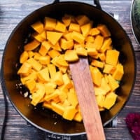 peeled and diced pumpkin added to the pot for cooking risotto