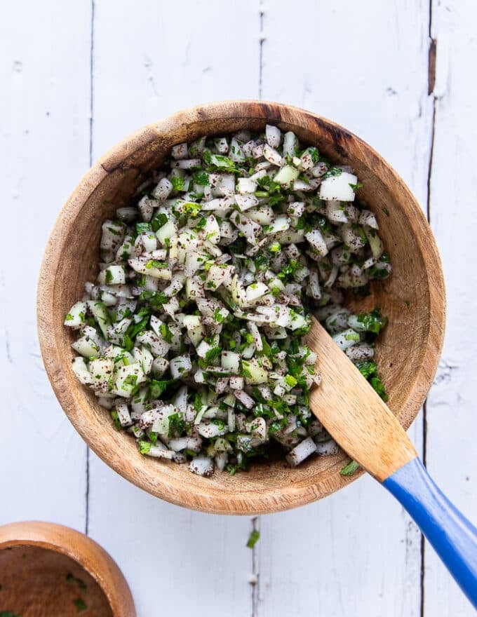 Sumac and onion salad ready in a wooden bowl 