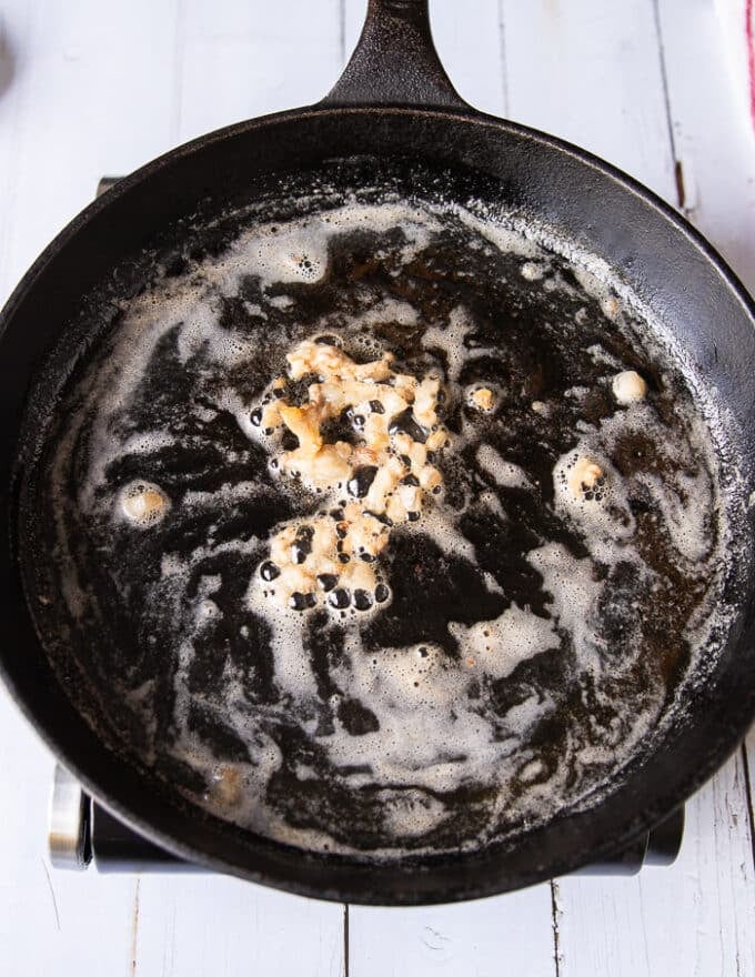 Lamb fat and butter melting a large cast iron skillet 