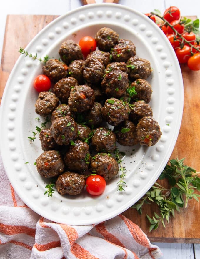 A plate filled with the cooked air fryer meatballs garnished with parsley