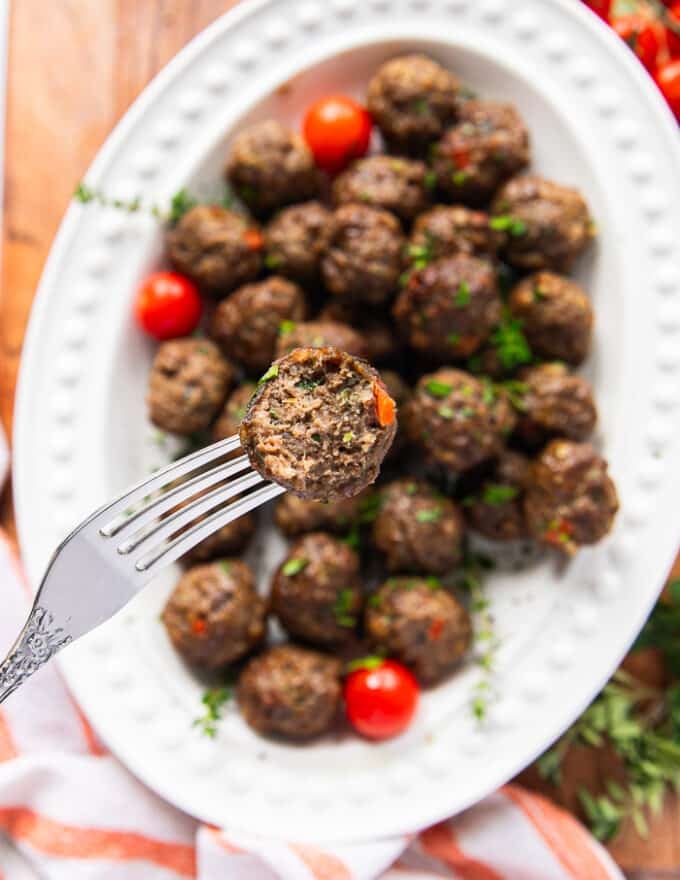 close up of one bitten air fryer meatball showing the texture and juicy meatballs