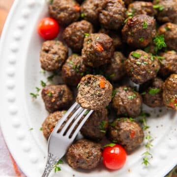 Air fryer Meatballs on a fork bitten and showing how perfectly cooked and juicy the meatballs are