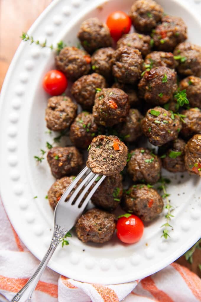 Air fryer Meatballs on a fork bitten and showing how perfectly cooked and juicy the meatballs are