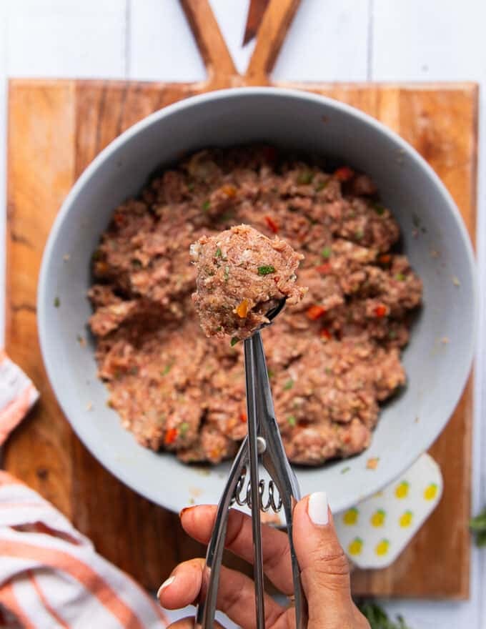 A scoop filled with the air fryer meatballs mixture