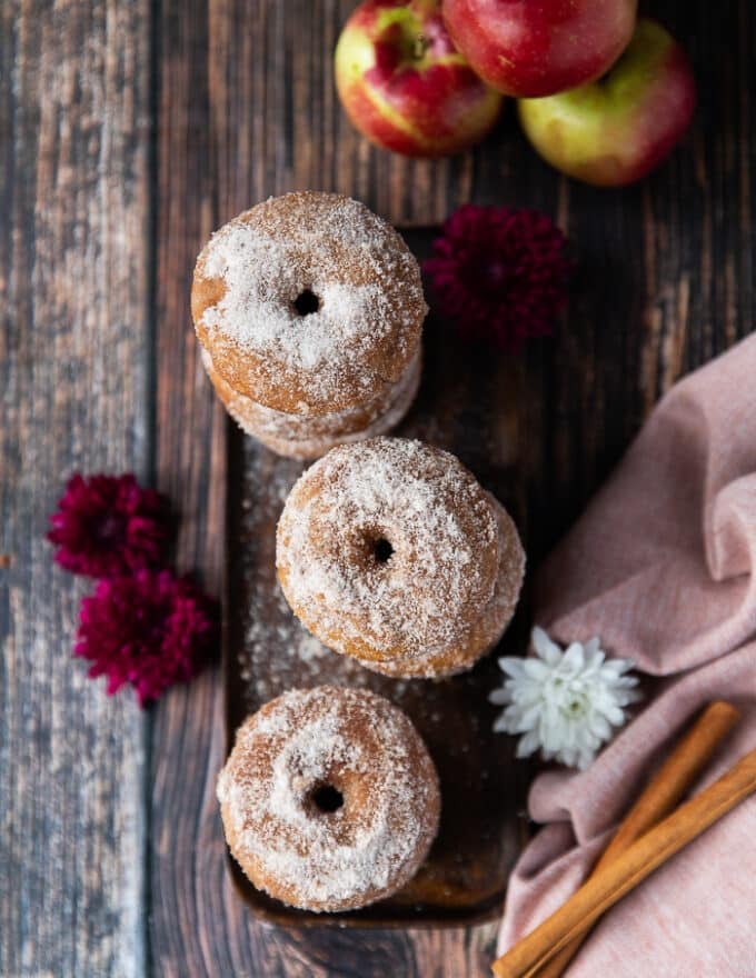 top view of all apple cider donuts now dipped in melted butter and cinnamon sugar