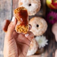 a hand holding a the apple cider donut spread with apple butter close up
