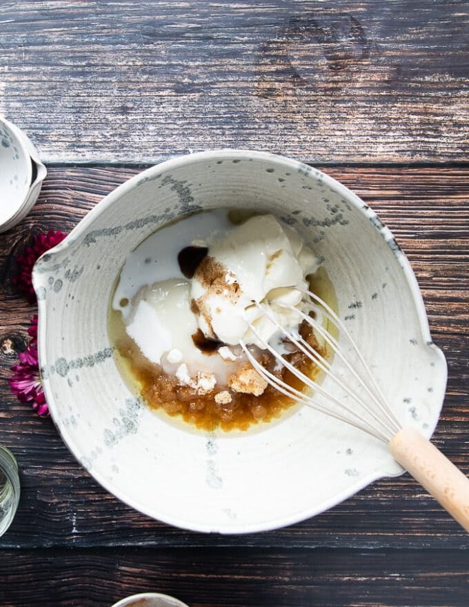 All the wet ingredients are mixed together in a large bowl to make apple cider donuts