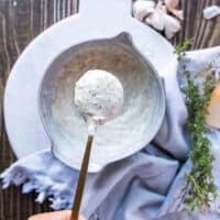 The garlic parmesan sauce mixed in the bowl and a spoon showing off the final texture