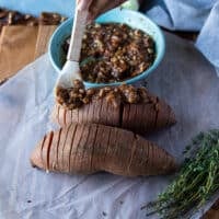 A hand repeating the same with the sweet mixture, adding the pecan cinnamon sugar mixture between the slices of sweet potatoes