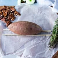 A sweet potato is placed right over the chopsticks