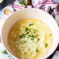 Butter melted in a skillet with diced onions and herbs