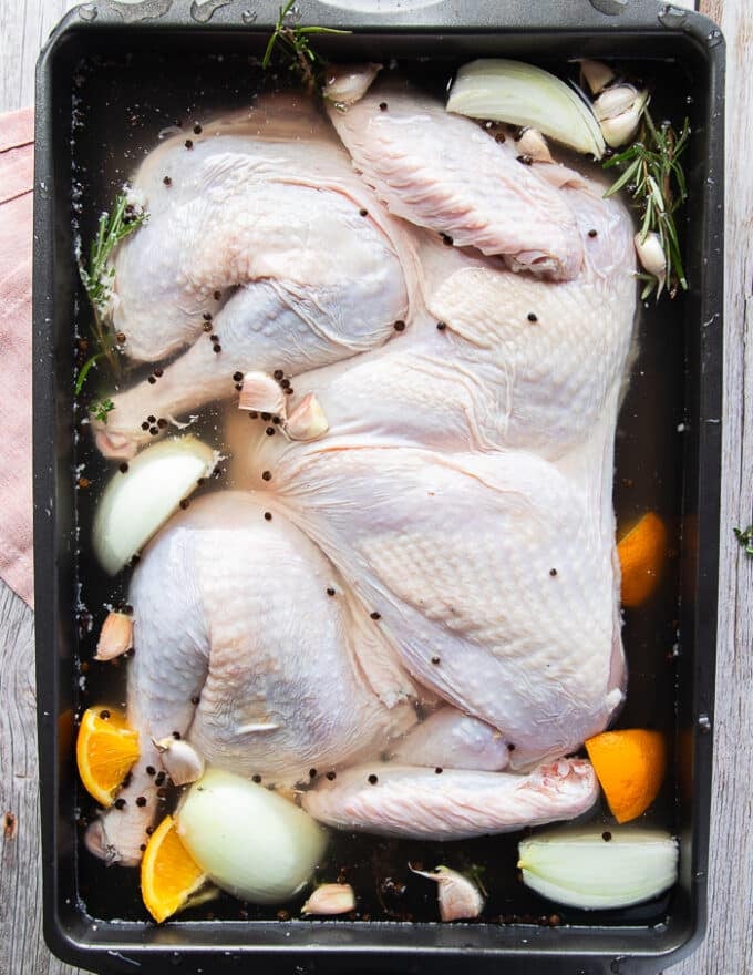 The turkey placed in to the brining solution in the large pan