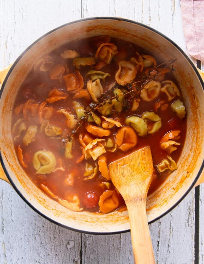 Tortellini fulled cooked in the tomato broth and tortellini soup is ready for cream or can be eaten as is