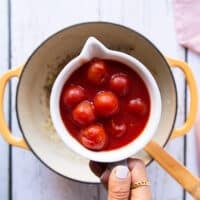 canned cherry tomatoes in a bowl ready to add to the soup