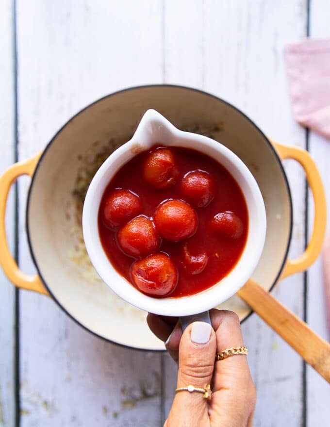 canned cherry tomatoes in a bowl ready to add to the soup