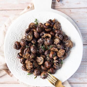 A plate of air fryer mushrooms and a fork in the plate