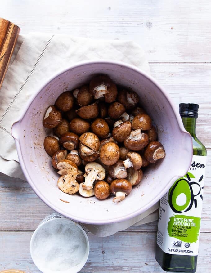 The mushrooms are tossed in a large bowl with the salt, pepper, soy sauce and oil 