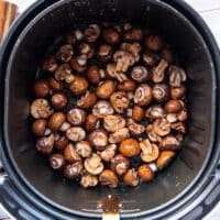 The mushrooms placed in the air fryer in a single layer