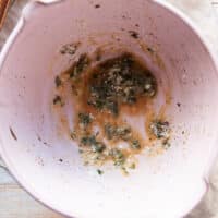 The melted butter , Parmesan , seasoning and fresh herbs is added to a large bowl.