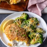 a plate of baked cod recipe with one bite taken off showing the texture