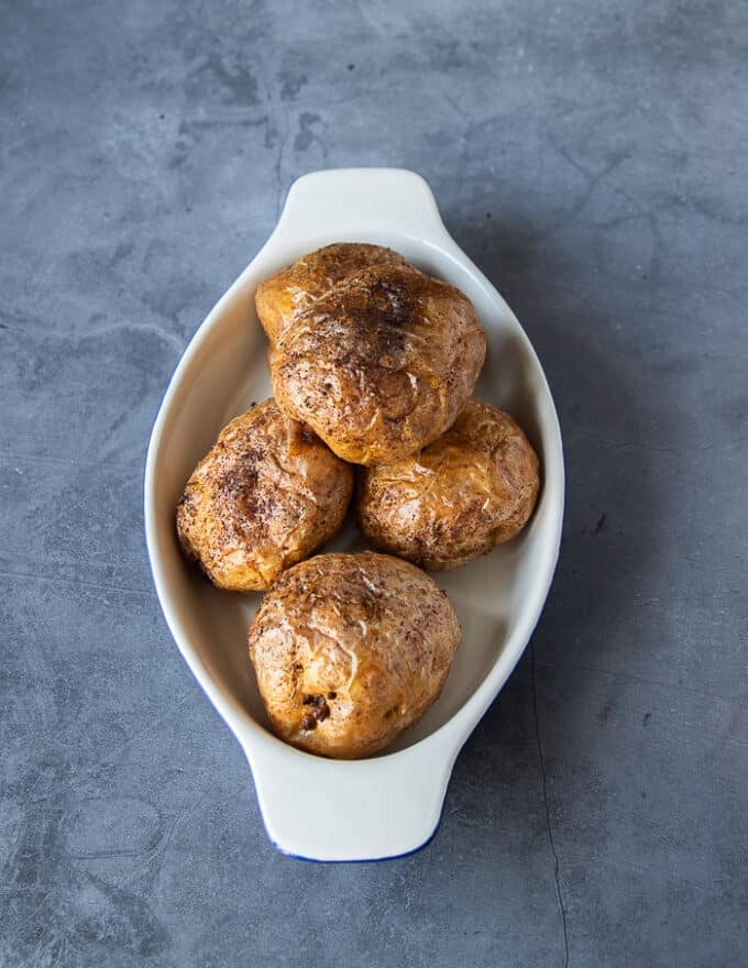 A plate of baked potatoes whole