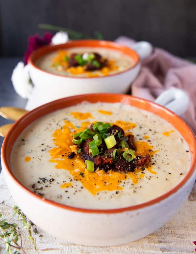 One close up bowl side view of the potato soup recipe showing close up of the toppings and textures 