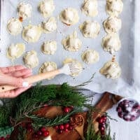 A hand brushing the pastry with an egg wash before baking