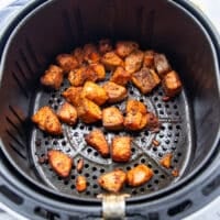 Golden cooked and crisp salmon bites in the air fryer basket ready in 7 minutes