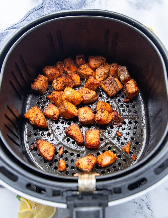 Golden cooked and crisp salmon bites in the air fryer basket ready in 7 minutes