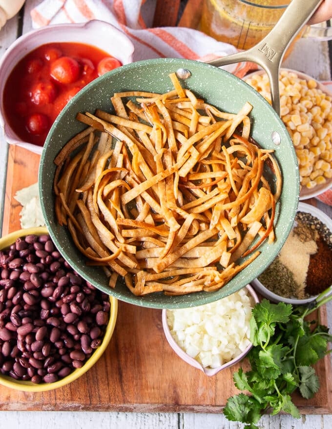 Golden fried tortilla strips a the frying pan. 