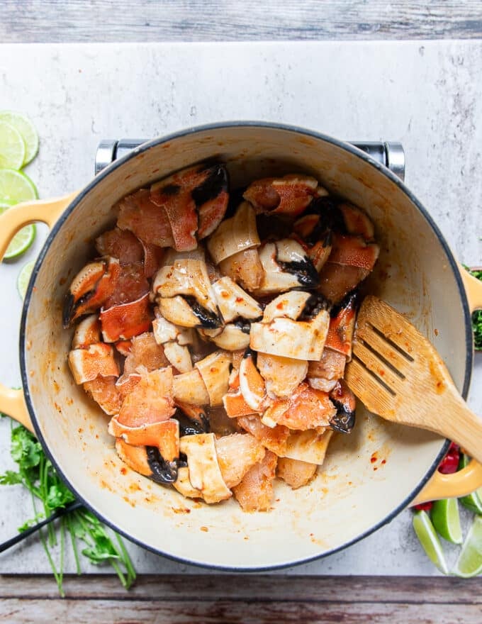 The jonah crab claws are added to the pot and tossed with the garlic butter sweet chilli sauce.