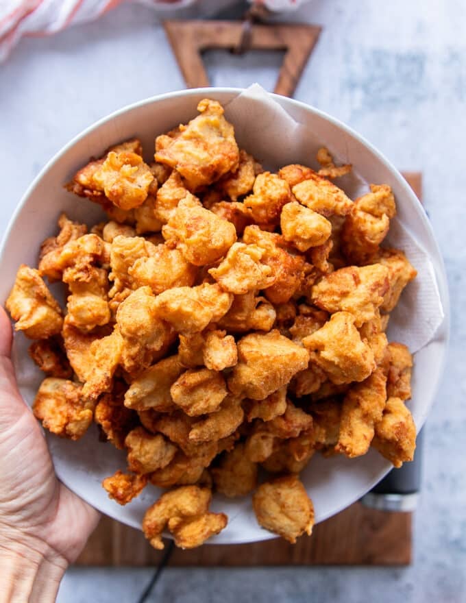 All the chicken fried and golden and placed on paper towels in a plate to drain from any excess oil 