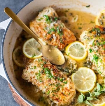 close up of the pan seared cod in the pan laced with lemon butter and capers