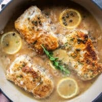 The stock and wine are added to the same pan of the golden cod fish and simmering