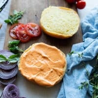 Burger buns spread generously with spicy mayo