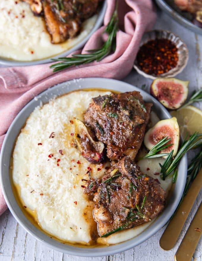 Close up of lamb loin chops seared and cooked, served with the fig rosemary butter and served over mashed potatoes 