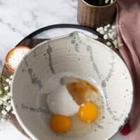 The cake batter bowl with egg, sugar and vanilla added